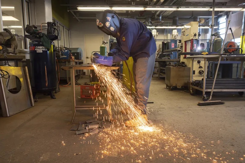 William Kohler, 16, a sophomore, was torch cutting steel in the welding program on Dec. 14, 2022.